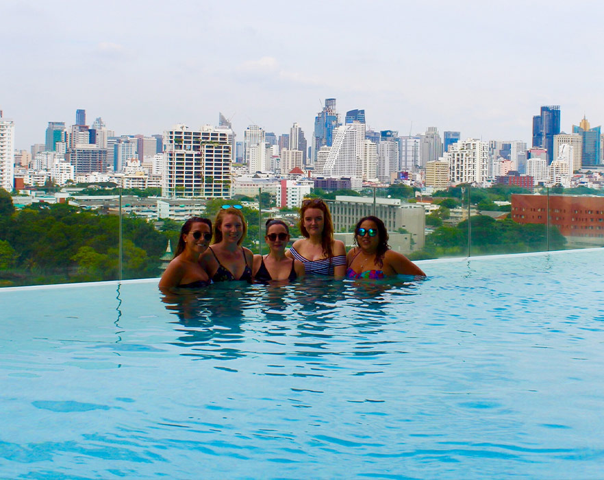 Friends in infinity pool, Thailand