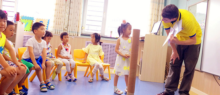 teacher teaching small chinese girl