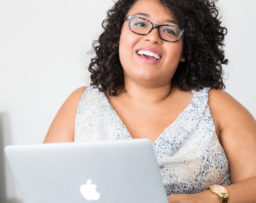 woman on laptop smiling