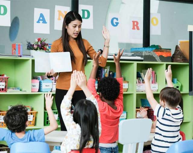 tefl teacher highfiving students