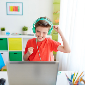 young boy using headset to hear tefl lesson