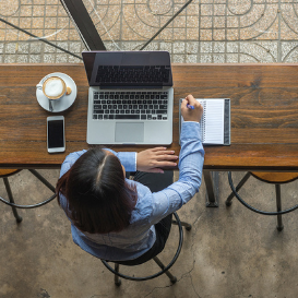 girl studying for TEFL exam using laptop