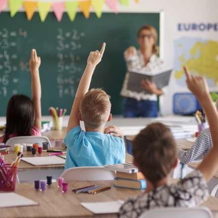 HANDS RAISED IN CLASSROOM