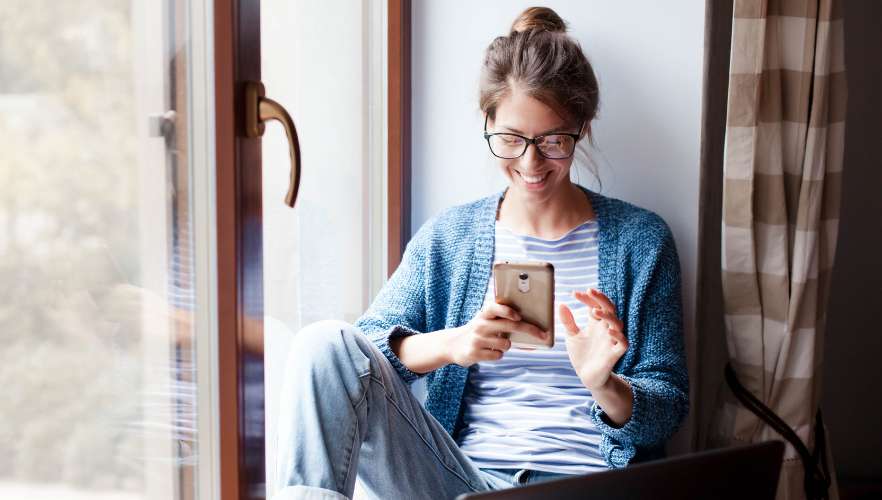 happy woman looking at phone