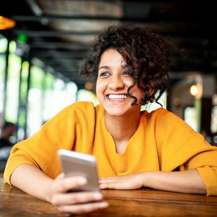 WOMAN SMILING WITH PHONE